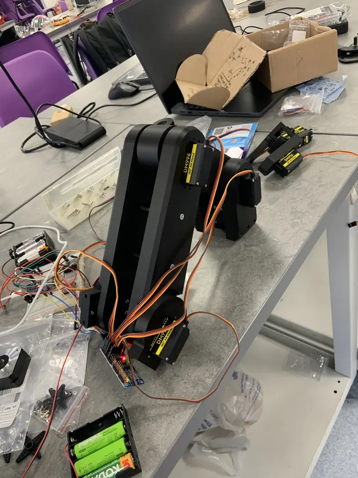 Arm assembly mid-build with servo wiring
